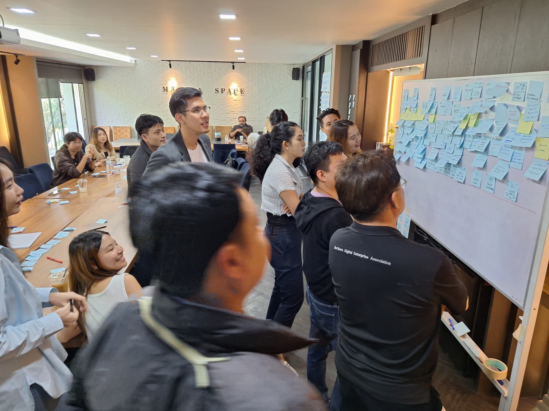Sticky notes and ideas covering a wall during an earlier community build session